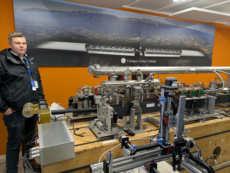 Christian Grefe in front of a model of the CLIC accelerator