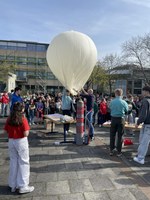 The physics class fills the weather balloon with helium